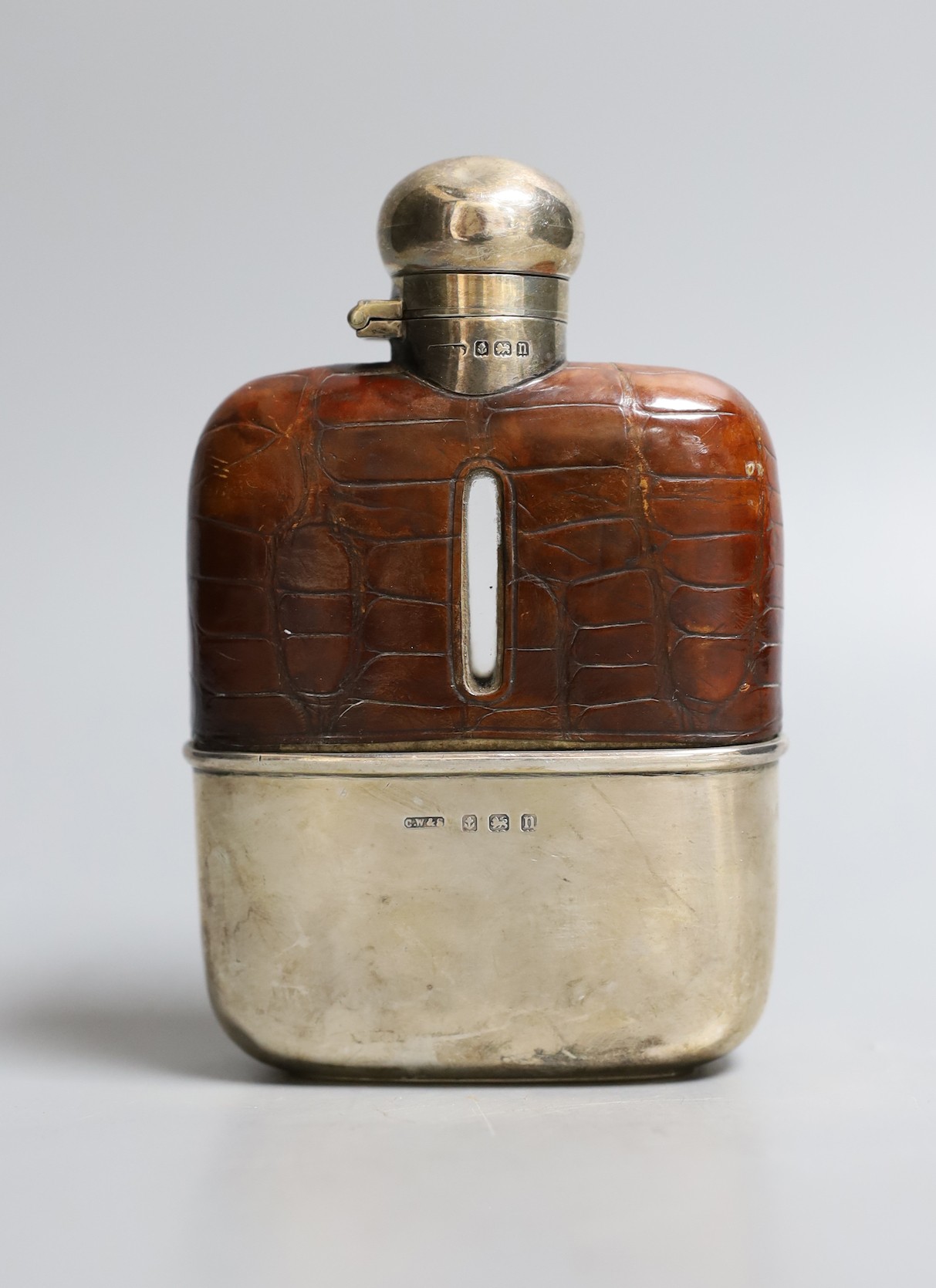 A George V silver and crocodile skin mounted glass hip flask, Charles Westwood & Sons, Birmingham, 1912, 12.5cm.
